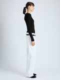 Side image of model wearing Cassidy Sweater in Superfine Merino Silk in BLACK