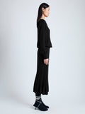 Side image of model wearing Eden Knit Dress in Superfine Merino Silk in black