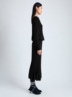 Side image of model wearing Eden Knit Dress in Superfine Merino Silk in black