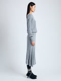 Side full length image of model wearing Eden Knit Dress in Superfine Merino Silk in LIGHT GREY MELANGE