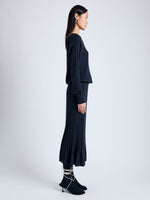 Side full length image of model wearing Eden Knit Dress in Superfine Merino Silk in NAVY