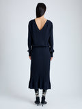 Back full length image of model wearing Eden Knit Dress in Superfine Merino Silk in NAVY