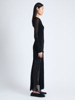 Side image of model wearing Anita Knit Dress in Sheer Mesh in BLACK