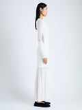 Side full length image of model wearing Anita Knit Dress in Sheer Mesh in OFF WHITE