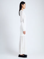 Side full length image of model wearing Anita Knit Dress in Sheer Mesh in OFF WHITE