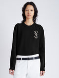 Cropped front image of model wearing Harrison Monogram Sweater in Wool Jacquard in black