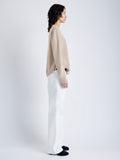 Side image of model wearing Harrison Monogram Sweater in Wool Jacquard in oatmeal