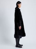 Proenza Schouler Side full length image of model wearing Fiona Coat in Shearling in BLACK