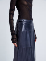 Proenza Schouler Detail image of model wearing Adriana Skirt in Paper Leather in MIDNIGHT