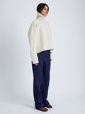 Proenza Schouler side image of model wearing Sandra Turtlneck Sweater in Lofty Eco Cashmere in ECRU