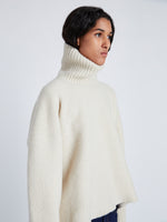 Proenza Schouler detail image of model wearing Sandra Turtlneck Sweater in Lofty Eco Cashmere in ECRU