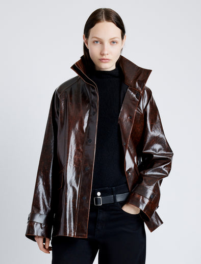 Proenza Schouler Front cropped image of model wearing Finch Raincoat In Lacquered Cotton in DARK BROWN/BLACK