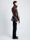 Proenza Schouler Side full length image of model wearing Finch Raincoat In Lacquered Cotton in DARK BROWN/BLACK