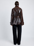 Proenza Schouler Back full length image of model wearing Finch Raincoat In Lacquered Cotton in DARK BROWN/BLACK