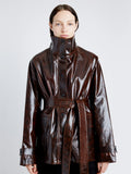 Proenza Schouler Detail image of model wearing Finch Raincoat In Lacquered Cotton in DARK BROWN/BLACK