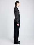 Proenza Schouler Side full length image of model wearing Sophie Long Sleeve Top in Sequin in BLACK