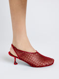 Side image of model wearing Perforated Slingback Pumps in RED