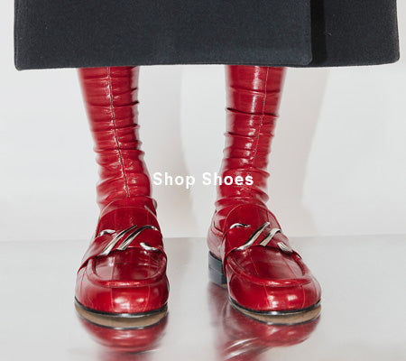 Cropped image of model wearing Monogram Loafers in Eel in Rosewood, 'Shop Shoes' overlaid