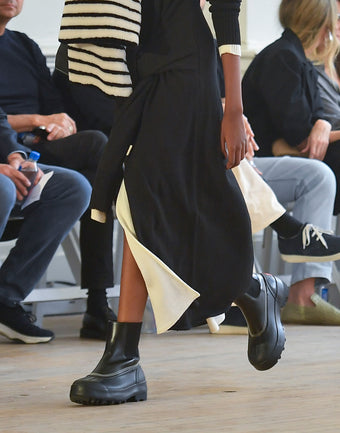 Cropped image of model walking Proenza Schouler SS25 Runway, wearing SOREL x Proenza Schouler Caribou boots in black