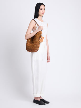 Image of model wearing Raffia Spring Bucket Bag in HONEY