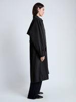 Side image of model wearing Clark Trench Coat in Cotton Nylon in BLACK