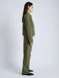 Side full length image of model wearing Barnes Jacket in Rumpled Cotton in DARK OLIVE