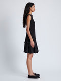 Side image of model wearing Martine Dress in Micro Pleat in BLACK