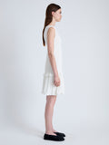 Side full length image of model wearing Martine Dress in Micro Pleat in OFF WHITE