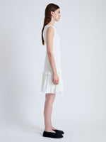 Side full length image of model wearing Martine Dress in Micro Pleat in OFF WHITE