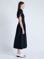 Side full length image of model wearing Balston Dress in Poplin in BLACK