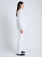 Side full length image of model wearing Carter Top in Tech Poplin in WHITE