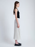 Side image of model wearing Pleated Miles Skirt in Crepe in WHITE/BLACK