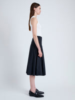 Side full length image of model wearing Peters Skirt in Tech Poplin in BLACK