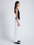 Side image of model wearing Sydnor Pants in Rumpled Cotton in white