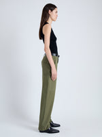 Side image of model wearing Sydnor Pants in Rumpled Cotton in Dark Olive