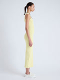 Side full length image of model wearing Cole Knit Dress in Viscose Rib in PALE YELLOW