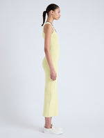 Side full length image of model wearing Cole Knit Dress in Viscose Rib in PALE YELLOW