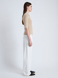 Side full length image of model wearing Cooper Knit Polo in Micro Cable in CASHEW