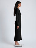 Side image of model wearing Phillips Knit Dress in Micro Cable in black