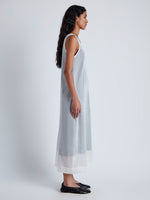 Side image of model wearing Simmons Sheer Knit Dress in OFF WHITE/BLACK