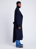 Proenza Schouler Side full length image of model wearing Constance Coat in Pinstripe Wool Cashmere in NAVY MELANGE