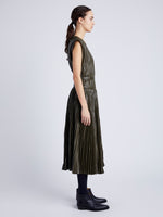 Proenza Schouler Side full length image of model wearing Rosalyn Pleated Skirt in Lightweight Faux Leather in DARK FERN