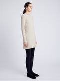 Proenza Schouler Side full length image of model wearing Apollo Knit Dress in Cloque in OATMEAL MELANGE