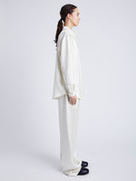 Proenza Schouler Side full length image of model wearing Raven Shirt in Satin in ENOKI