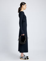 Image of model holding Slide Bag in Smooth Nappa in BLACK