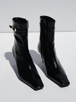 Proenza Schouler 3/4 front editorial image of Trap Ankle Boots in BLACK