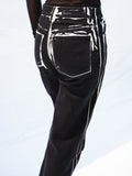 Detail cropped image of model wearing Ryman Jean in black multi