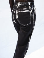 Detail cropped image of model wearing Ryman Jean in black multi