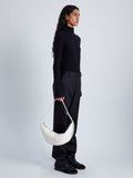 Image of model holding Slide Bag in Smooth Nappa in WHITE