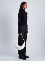 Image of model holding Slide Bag in Smooth Nappa in WHITE